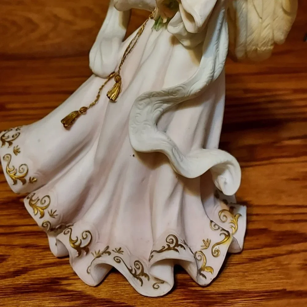 BEAUITFUL ANGLE HOLDING FLOWERS AND A BIRD IN HER HAND